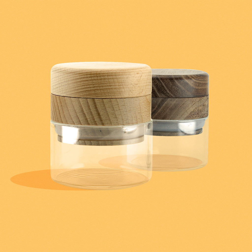 Wood & glass grinder in Beech and Walnut finish on yellow background