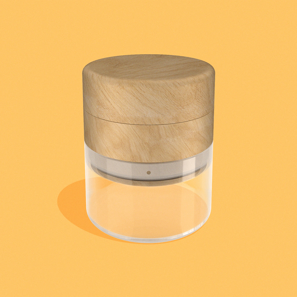 Wood & glass grinder in Beech finish on yellow background