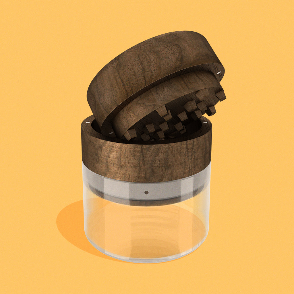 Wood & glass grinder in Walnut finish on yellow background