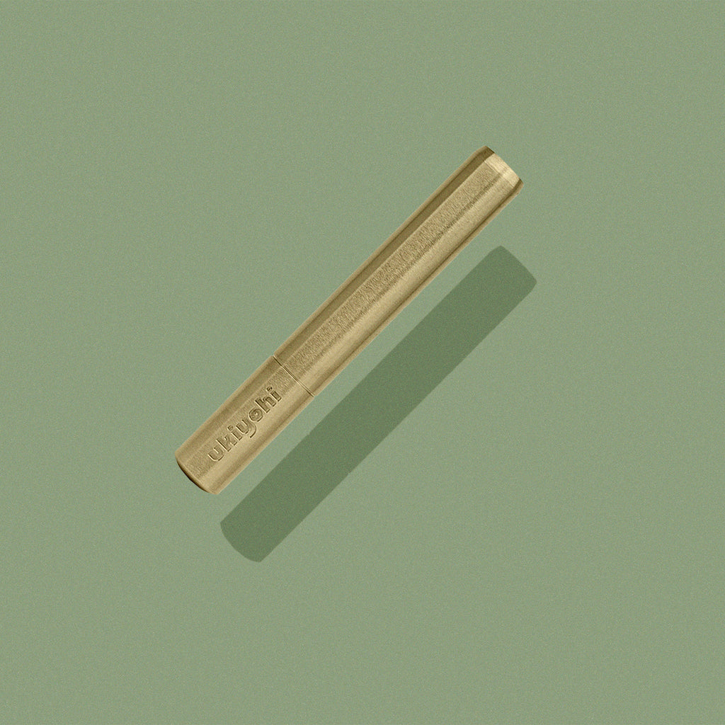 M1 Pipe in Brass on green background